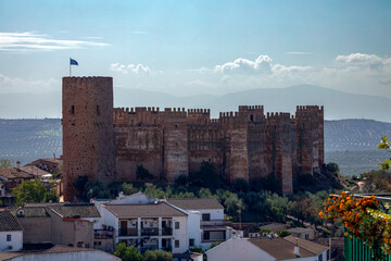 Obraz premium Spectacular full view of the walls and turrets of the medieval castle of Burgalimar in Baños de la Encina, Jaén, Andalusia, Spain with evening light