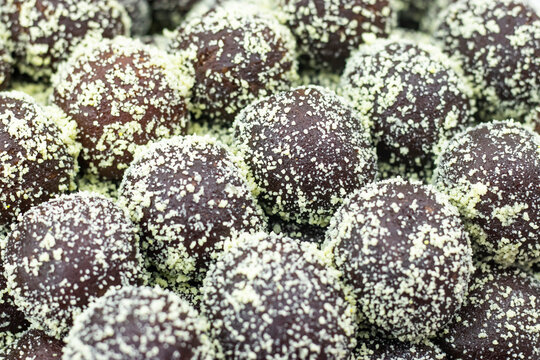 Golap Jam or Gulab Jamun coating with coconut texture closeup side view of Indian, pakistani and bangladeshi sweet dessert food