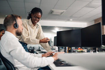 Customer service representatives working together in modern office