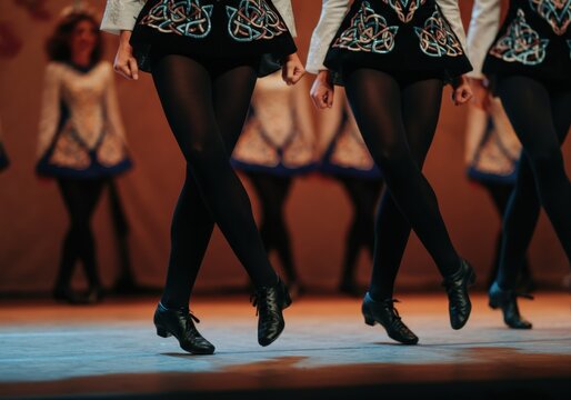 Group of irish dancers performing a traditional dance on stage, wearing celtic costumes and hard shoes