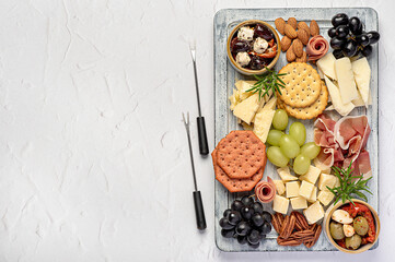 Blank food photography of antipasto with parmesan, sheep cheese, cheddar, serrano ham, prosciutto, grapes,  pecan; almond, crackers; marinated olives with tomatoes, celebration, party