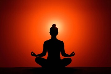 Silhouette of Tranquility: A woman in a serene yoga pose, bathed in the warm glow of a vibrant orange light, embodies peace and inner harmony.  