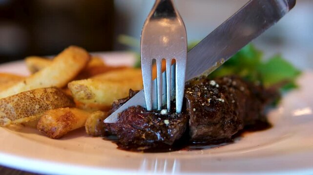 medium rare steak Carving tomahawk steak on cutting board.