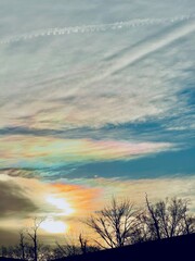 Rare fire iridescent clouds appearing overhead in the sky before sunset in the winter over Long...