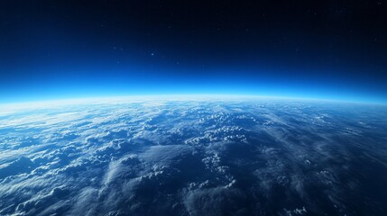 Fototapeta premium Planet Earth viewed from space, showing a curved horizon, clouds, and dark blue atmosphere.