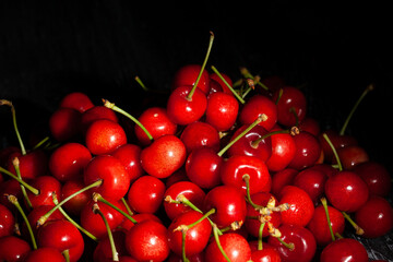 cherries heap on black background