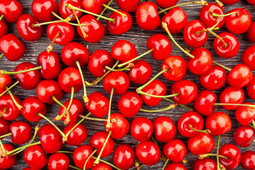 cherries on wood background top view