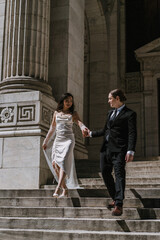 Wedding Couple Posing Gracefully Together on the Beautiful Steps of a Venue