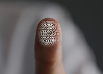 Man pressing finger to surface showing friction ridges pattern, closeup. Scanning fingerprint