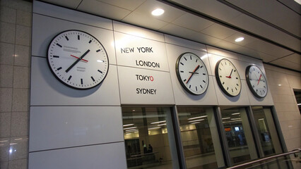 International Time Zones Wall Clocks in Modern Airport or Train Station
