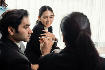 Diverse of business people from various ethnic group working in modern office environment. Productive and multi ethnic office workers engage in discussion for strategic business marketing. Meticulous