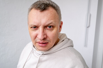 distorted face of sad and grieved very upset person, dissatisfied with his hard fate