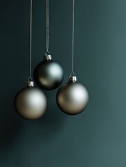 Elegant Christmas tree ornaments hanging on a minimal dark green backdrop, leaving space for personalized greetings.