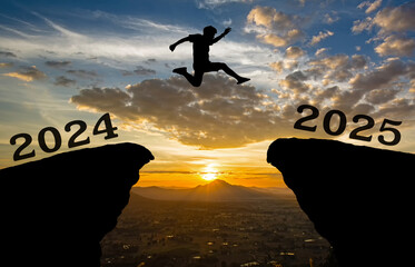 A young man jump between 2024 and 2025 years over the sun and through on the gap of hill silhouette...