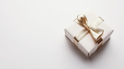 White elegant gift box with a gold ribbon isolated on white background. Top view