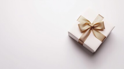 White elegant gift box with a gold ribbon isolated on white background. Top view