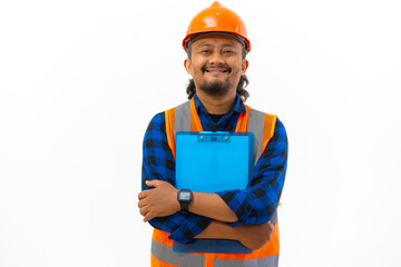 Indonesian male construction worker in full safety gear posing using clipboard while smiling looking at camera, construction and industry concept, isolated on white background.