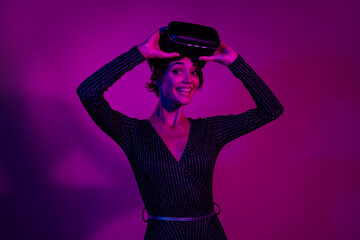 Photo portrait of lovely young lady take off headset gamer wear trendy overall garment isolated on neon light pink color background