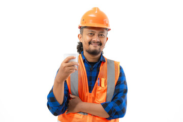 Indonesian male construction worker in full safety suit enjoying a cup of black coffee while working, construction and industry concept, isolated on white background.