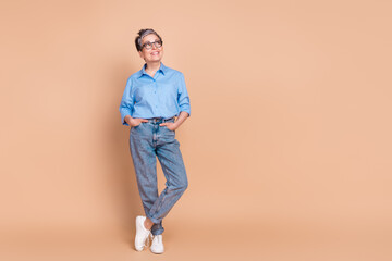 Fototapeta premium Photo portrait of gray hair pensioner experienced business lady wearing formalwear looking empty space isolated on beige color background
