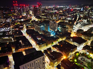 Aerial Night View of Illuminated Central Manchester City and Downtown Buildings, England United Kingdom. High Angle Footage Was Captured with Drone's Camera on May 4th, 2024 During Midnight.