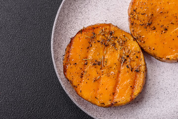 Pumpkin cut into slices and grilled with rosemary and spices