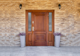 Designer entrance door to a country house. Modern design. Luxurious exterior. Facade of a modern building with modern doors.