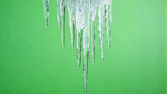 Shimmering icicle swaying gently before falling. Green screen chromakey