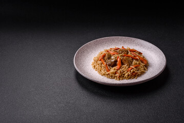 Delicious fresh pilaf with rice, carrots, meat, onions, spices and berries