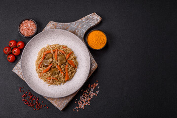 Delicious fresh pilaf with rice, carrots, meat, onions, spices and berries