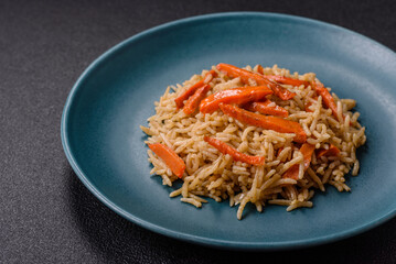 Delicious fresh pilaf with rice, carrots, meat, onions, spices and berries
