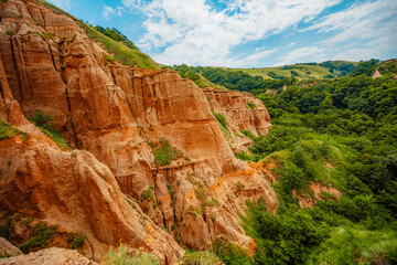 Obraz premium Red rocky slopes Rapa Rosie is a protected geological and floristic reservation area near Sebes alba in Romania
