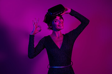 Photo portrait of lovely young lady take off headset okey dressed stylish overall garment isolated on neon light pink color background