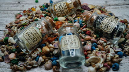 seashells Beautyful decoration with background of colorful small rocks, clay pot, class sand keepers and small magic portions 