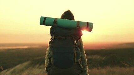 rest at nature. traveler concept. girl with a backpack long hair at sunset. the traveler meets the dawn in nature alone. woman is on vacation. happy man on vacation. hair wind. happy weekend of life. - Powered by Adobe