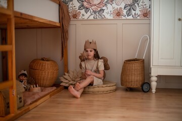 little girl sitting in a beautiful children's room
