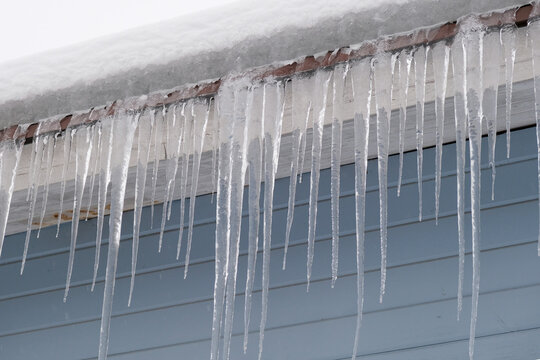 Beautiful icicles cascading from a roof and providing a view