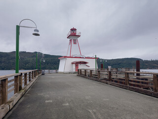 View of a Lighthouse on a duck during a cloudy day, historic site Port Alberni Lighthouse in Port Alberni