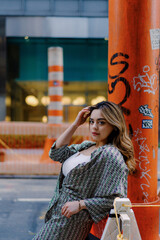 Urban Fashion: Stylish Woman in City Street, Confident and Chic