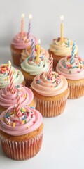 Colorful cupcakes with sprinkles and candles on top, celebration