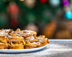 Authentic sweet Christmas French toast served with sugar and cinnamon in a Christmas atmosphere