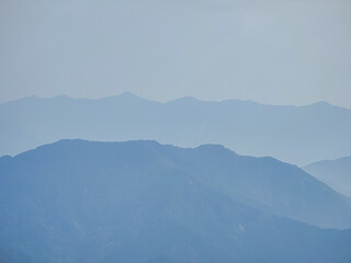 Vietnamese landscape with mountain scenery and shadows. Layers of mountains. Da Nang province, Vietnam. Aerial drone view