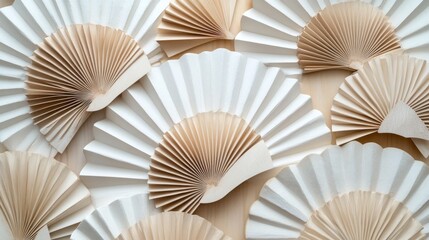 White and beige paper fans arranged on wood.