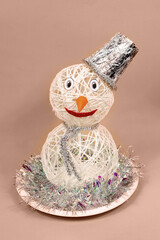 Snowman made of threads. Demonstrating color of 2025 year mocha mousse