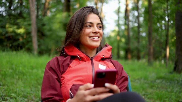 Young woman surfing the net and relaxing in the nature