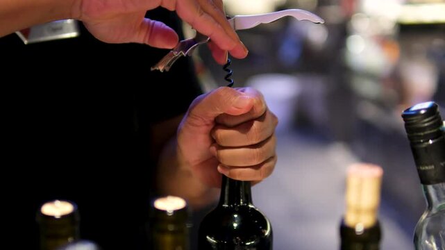Opening bottle of wine with electric corkscrew. Electric device corkscrew for alcohol. 