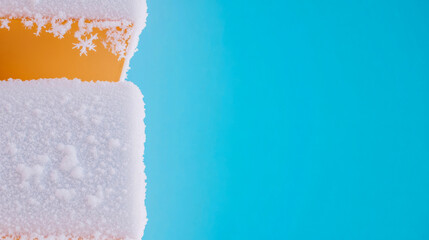 Winter snowflakes forming on orange surface against clear blue sky