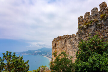 Landscape view old walls of fortress on Mediterranean coast. View of Alanya Castle, stone ruins in harbor Alanya, Turkey. High quality photo
