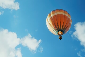 Fototapeta premium A hot air balloon soaring high in the clear blue sky, perfect for adventure and travel scenes