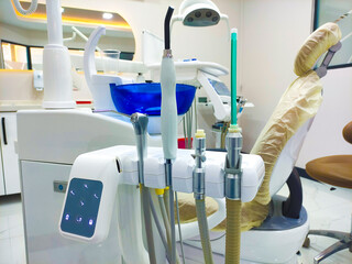 Patient chair used by  professionals for treatment and tools used by doctors in dental procedures. Dental treatment instruments and dental clinic. dental hospital and clinic © UniqDream